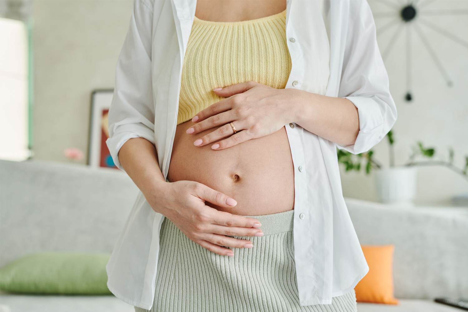 woman holds pregnant belly