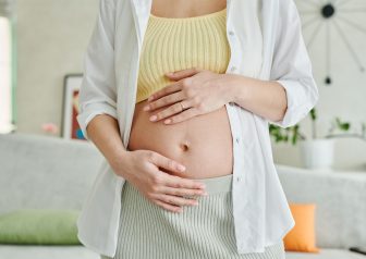 woman holds pregnant belly